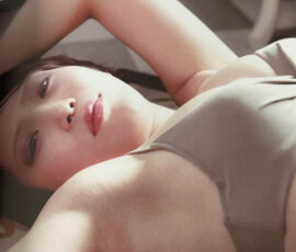 Sexy Japanese wrestler Utami Hayashishita posing provocatively in a skimpy grey bikini, dripping with heat in the Marigold Fanbook May 2024 photoshoot