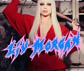Liv Morgan strikes a fierce pose on the PAPER Magazine cover, holding a barbed wire baseball bat, wearing a bold red outfit with platinum blonde hair and heavy makeup.